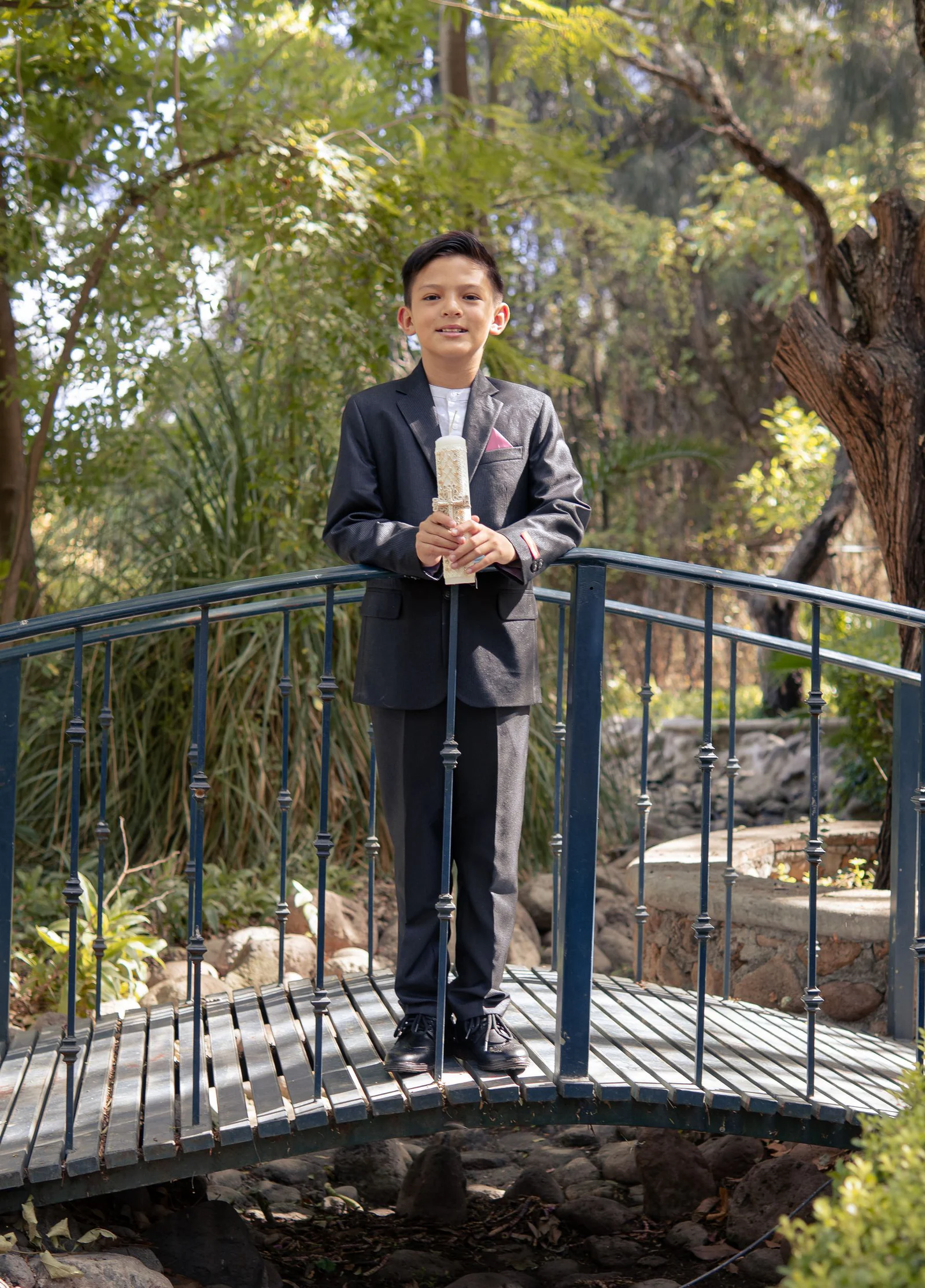Boy in black suit at park