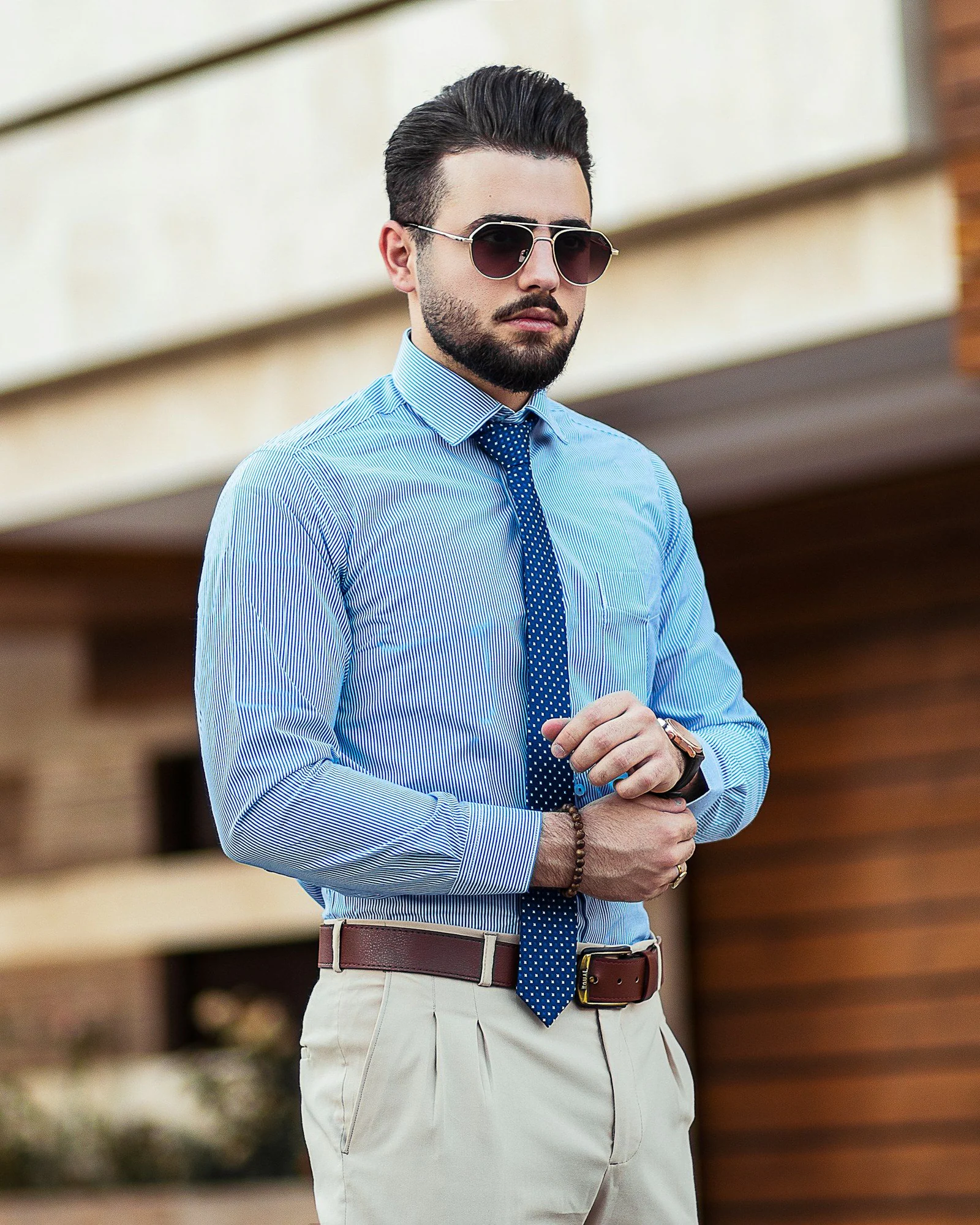 Man in blue dress shirt wearing black sunglasses