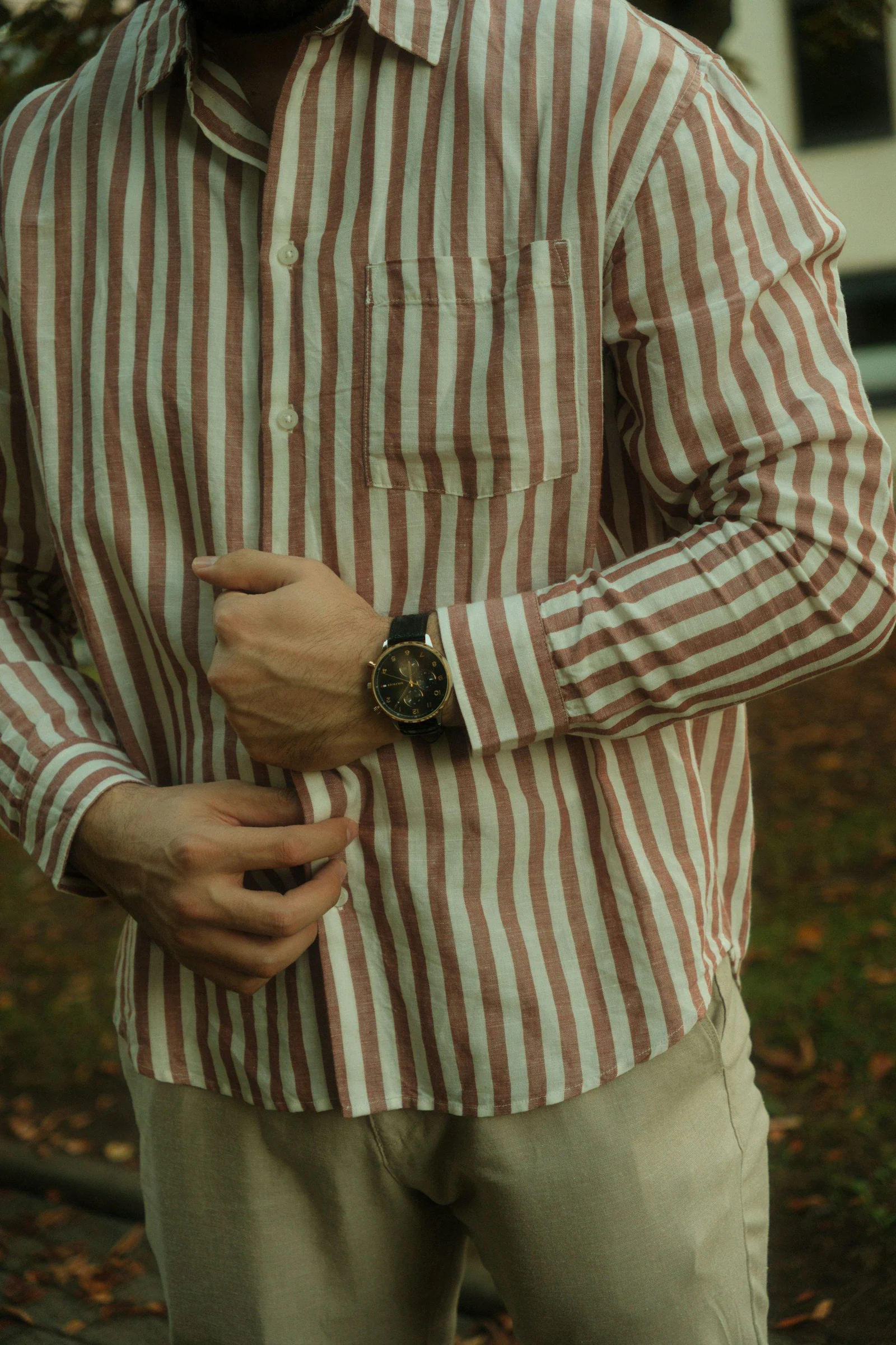 Person in striped shirt with watch