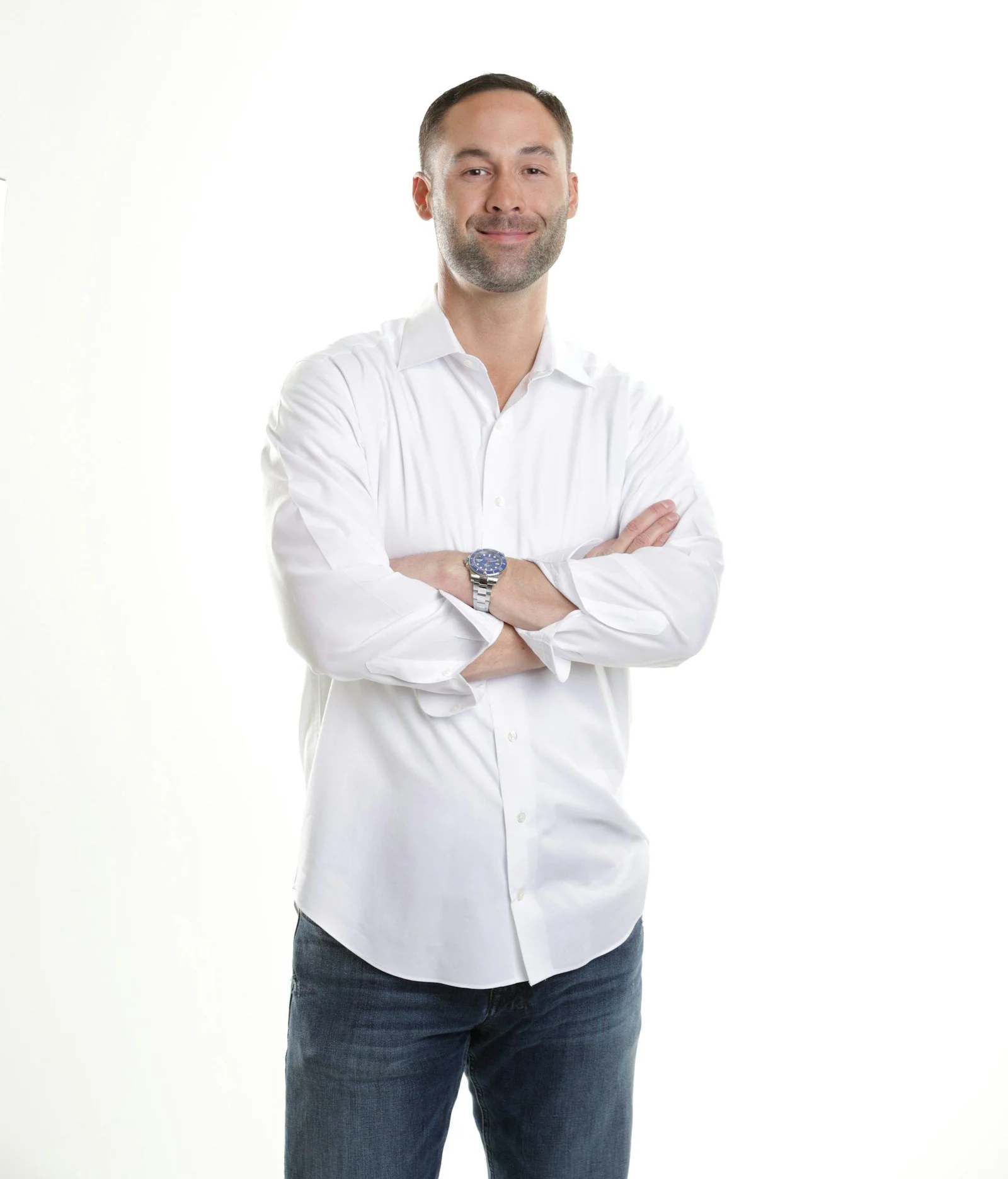Man in white dress shirt and blue denim jeans