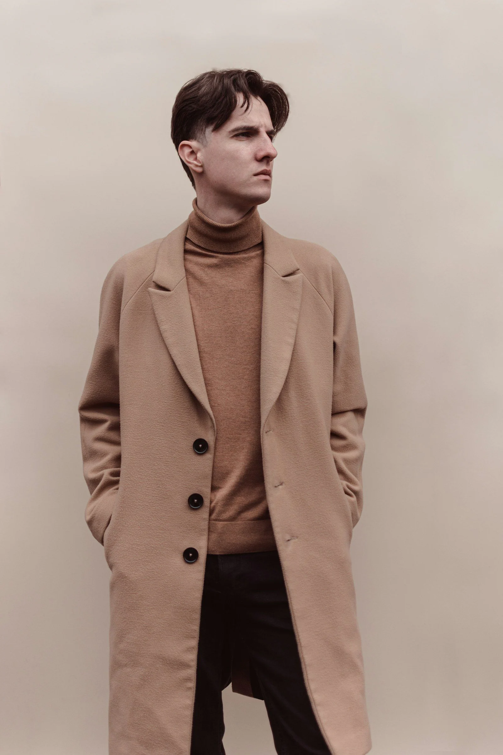 Man in brown coat and black pants