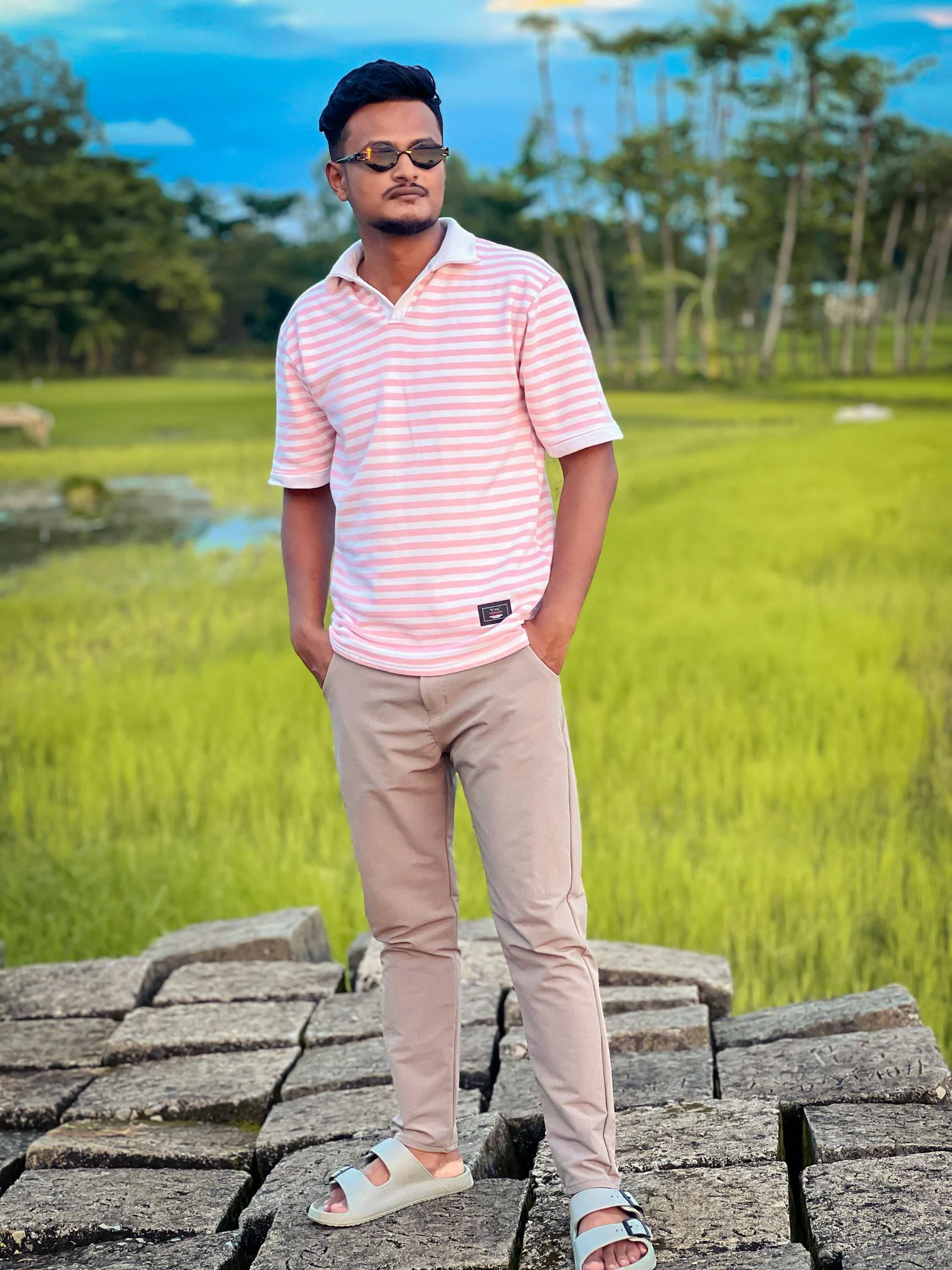 Man in striped shirt on stone