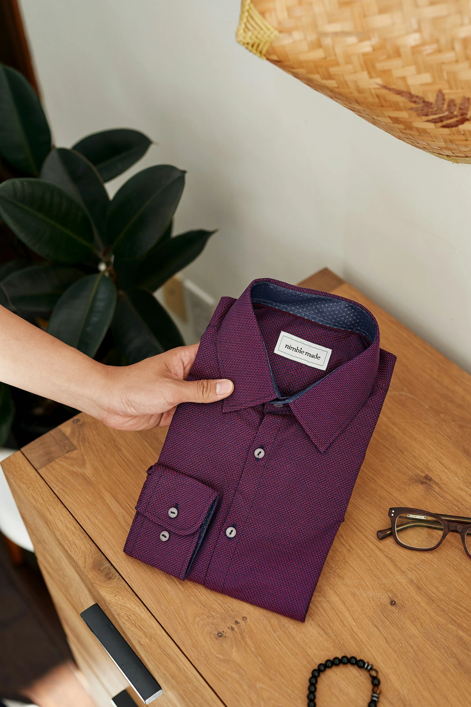 Purple button up shirt on brown wooden table