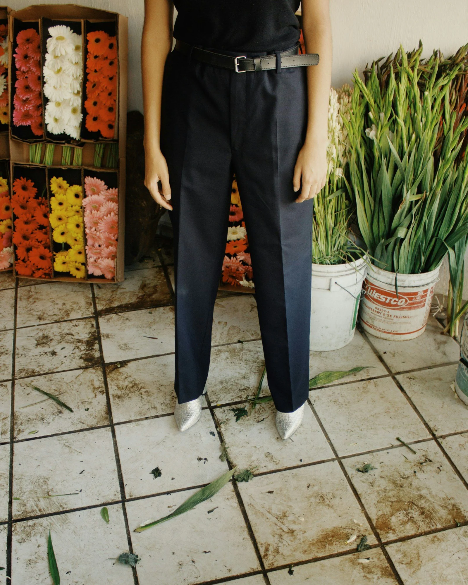 A mannequin wearing a black shirt and pants
