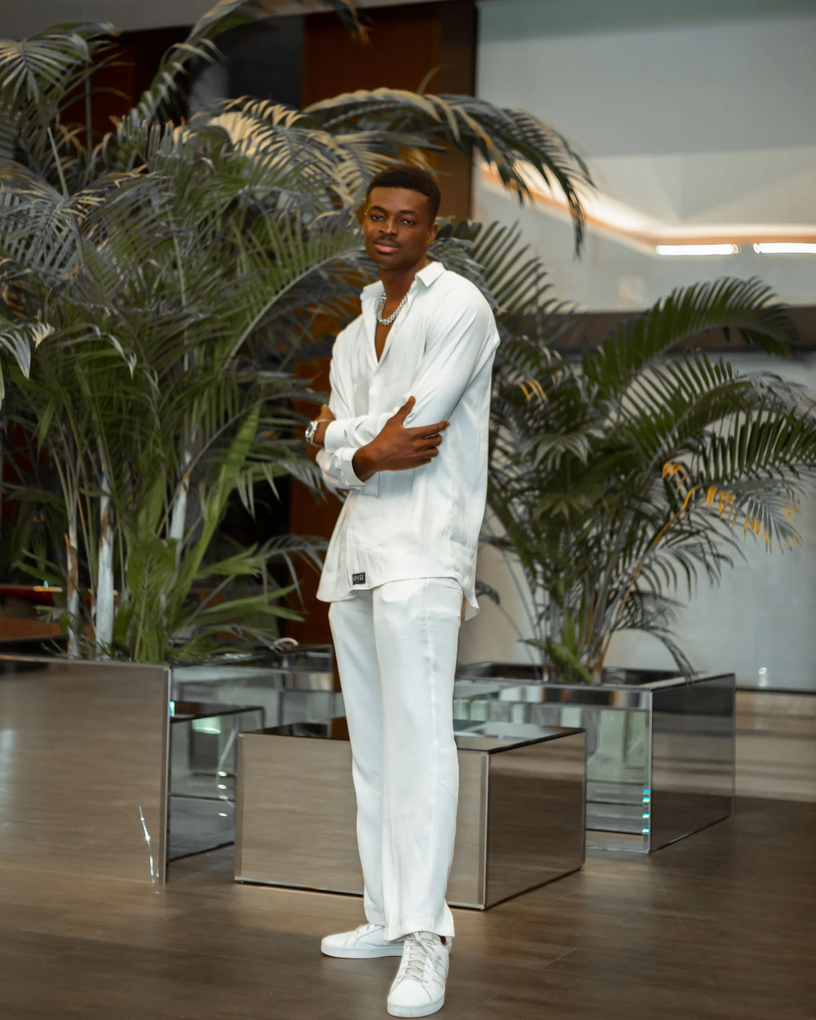 A man wearing white long sleeves and white pants