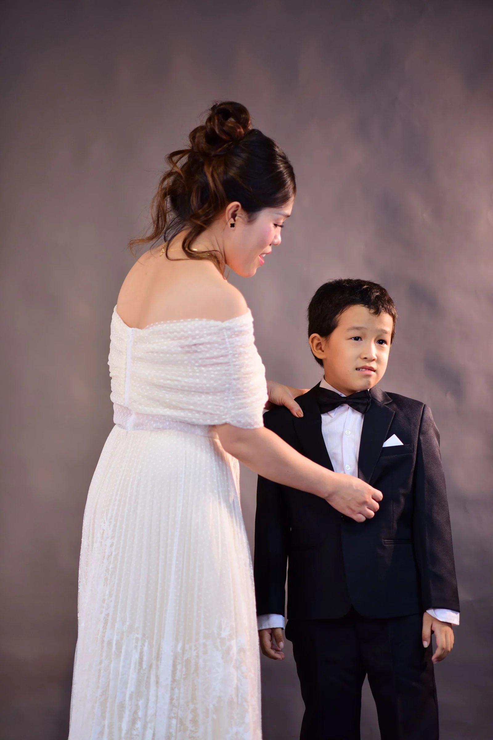 Elegantly dressed mother and son formal portrait