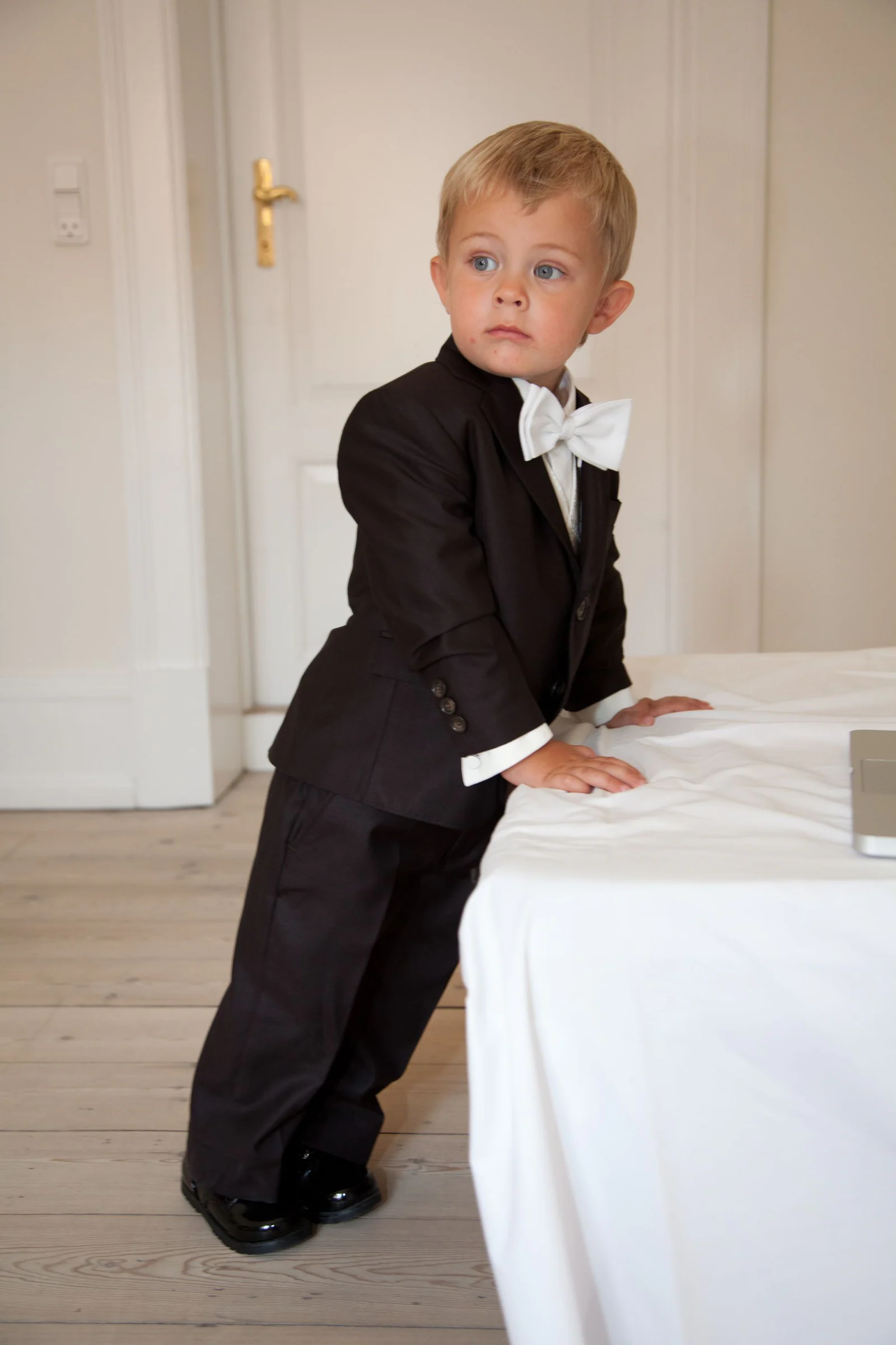 Boy leaning on white cloth