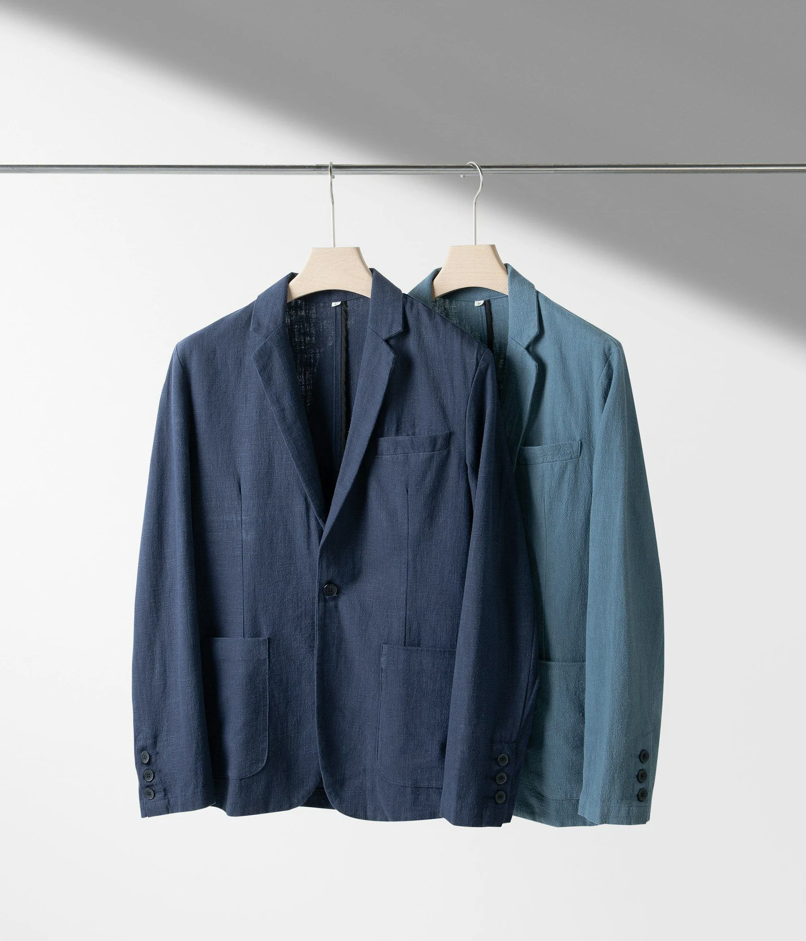 Two jackets hanging on a clothes line