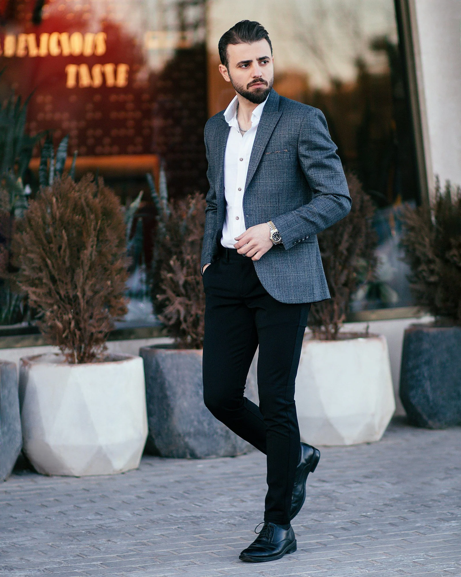 A man in a suit is standing outside