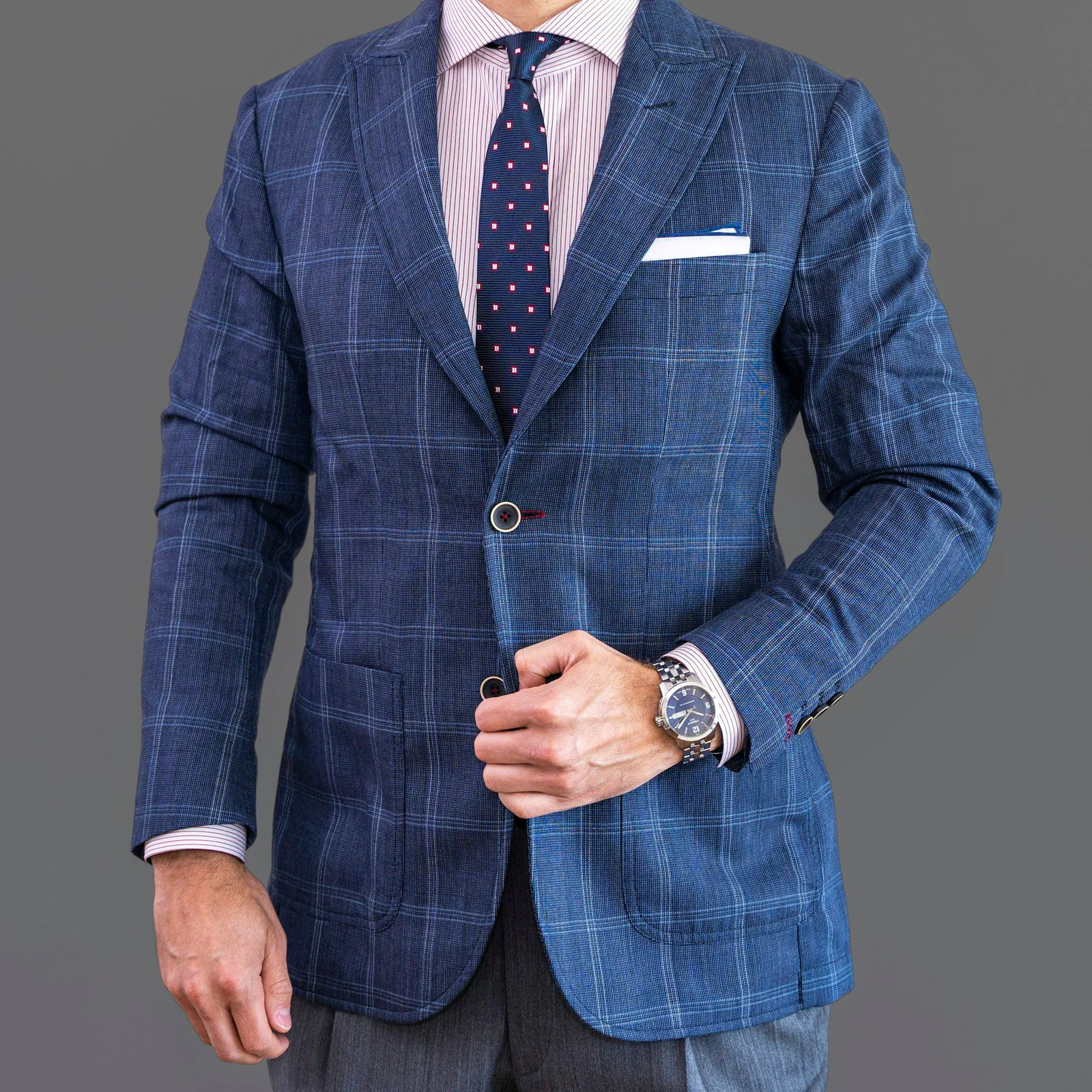 Man in blue blazer and black dress pants
