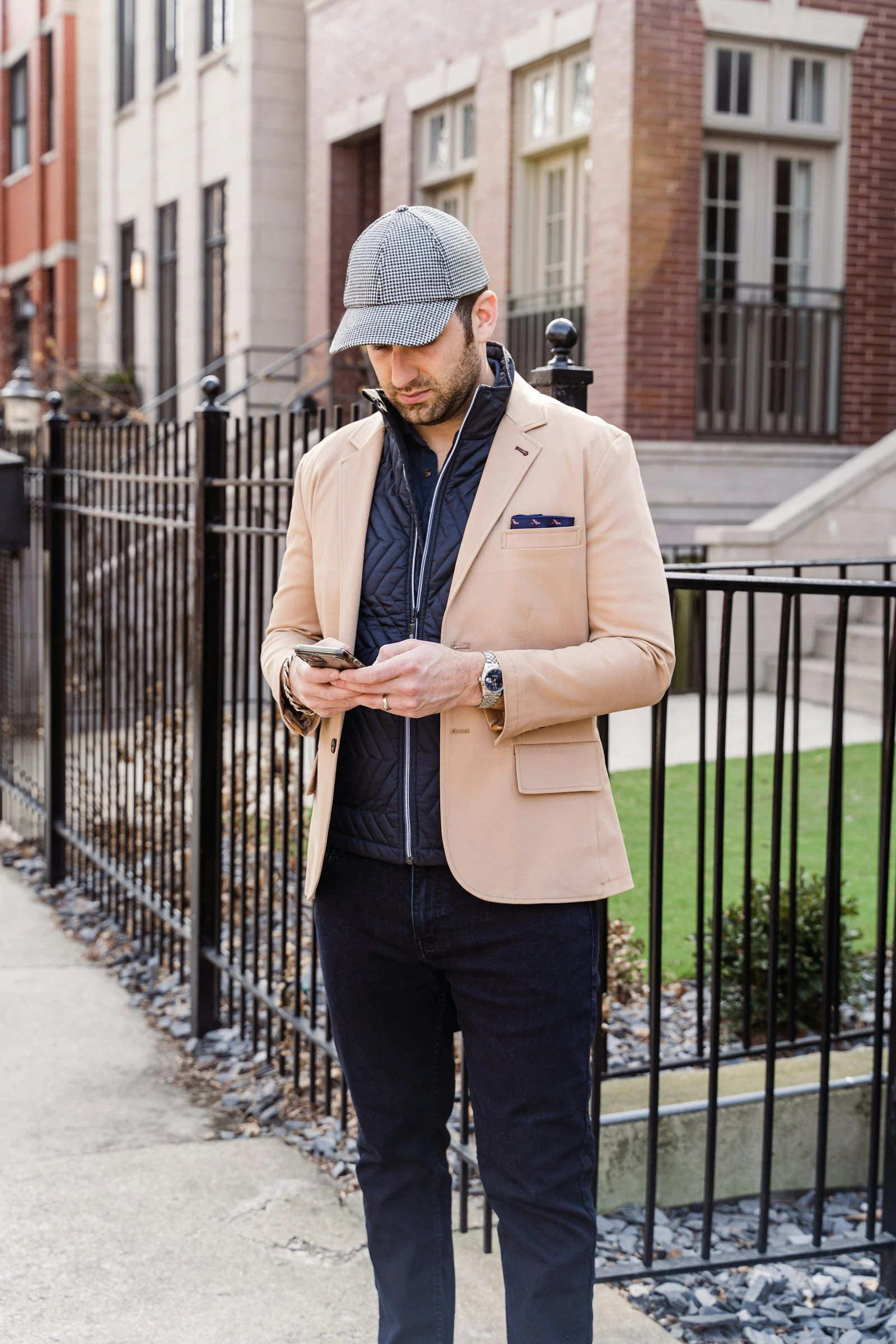 A man in a hat looking at his phone