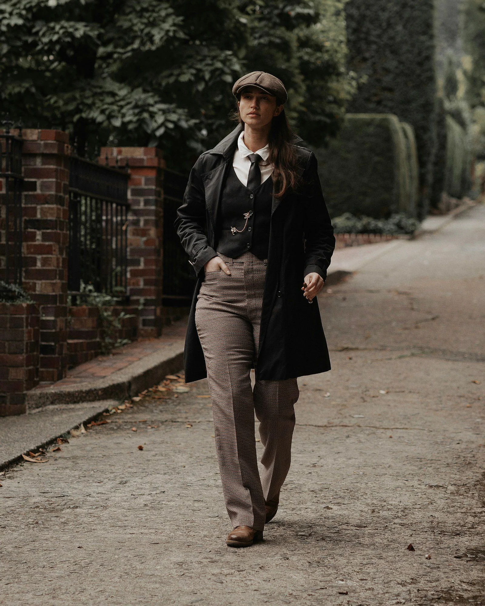 A woman in a suit and tie walking down a street