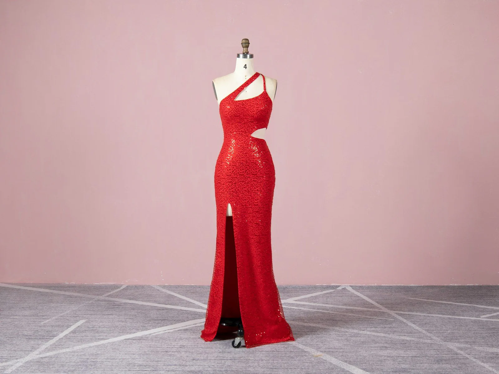A red dress on a mannequin in a room