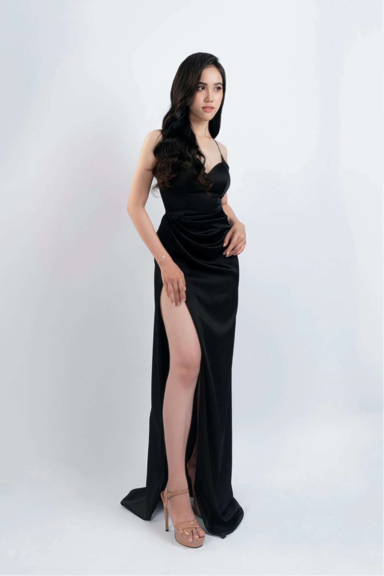Woman in a black satin evening gown