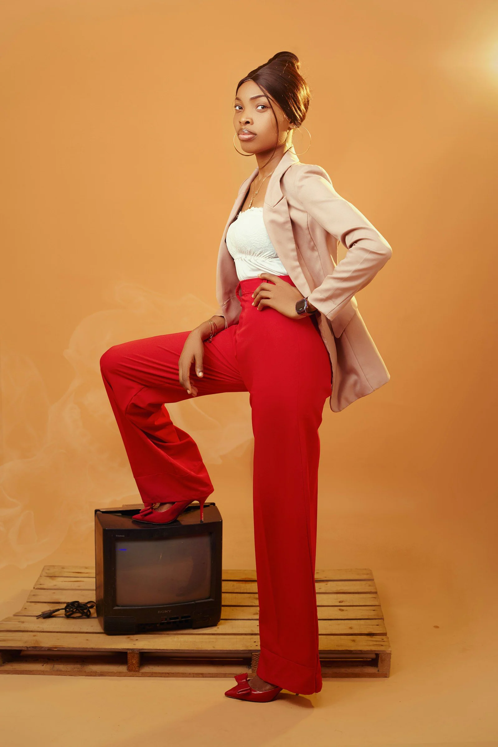 A woman in red pants and a white top