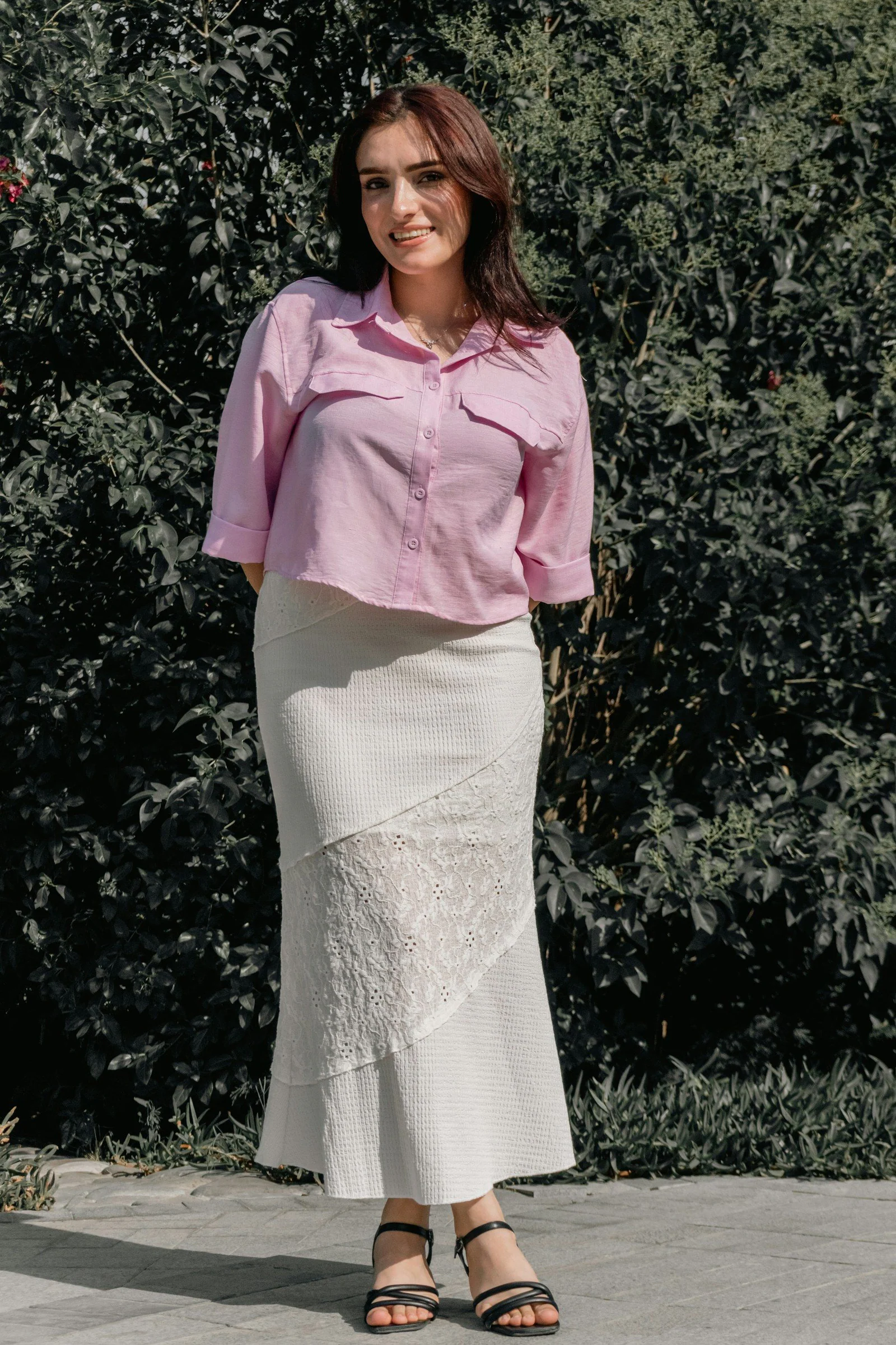 Woman in pink shirt and skirt