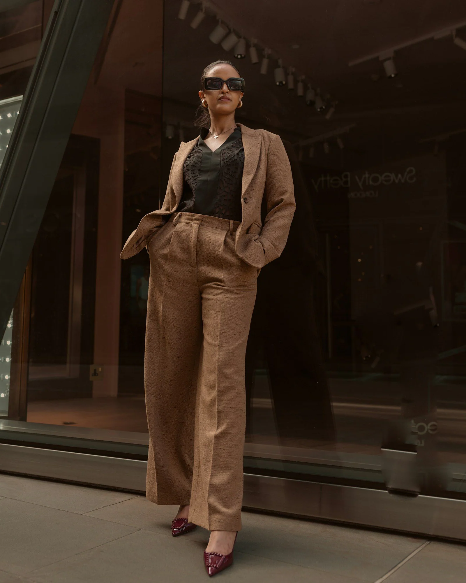 Stylish woman in a tailored pantsuit and sunglasses