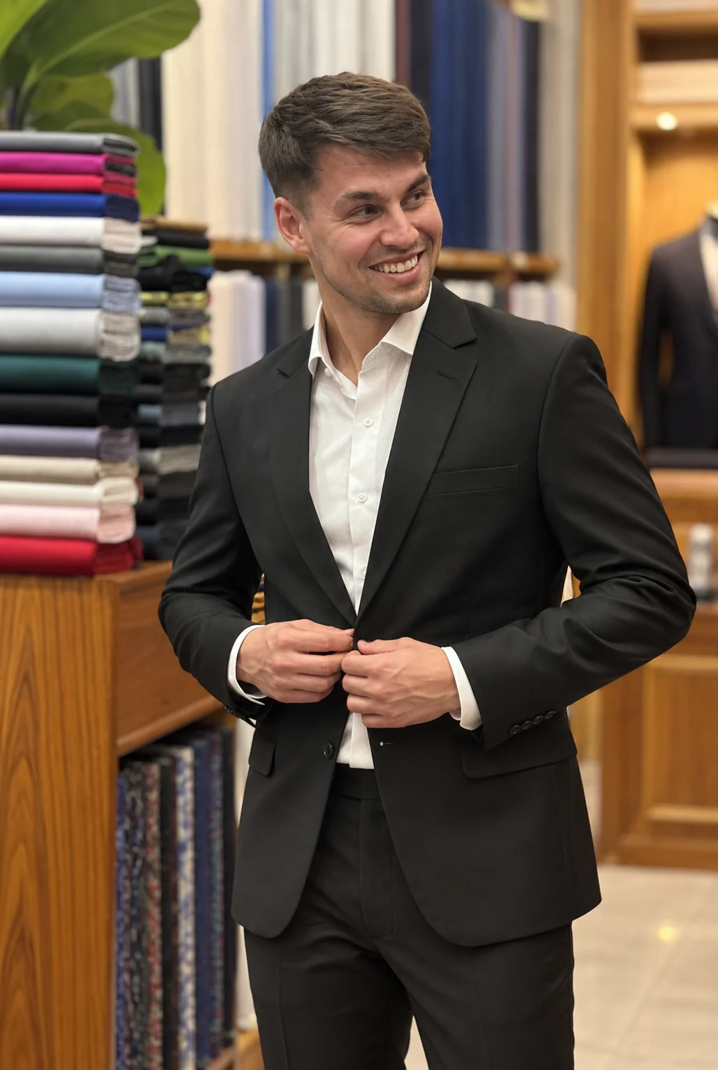 Black suit, buttoning the jacket