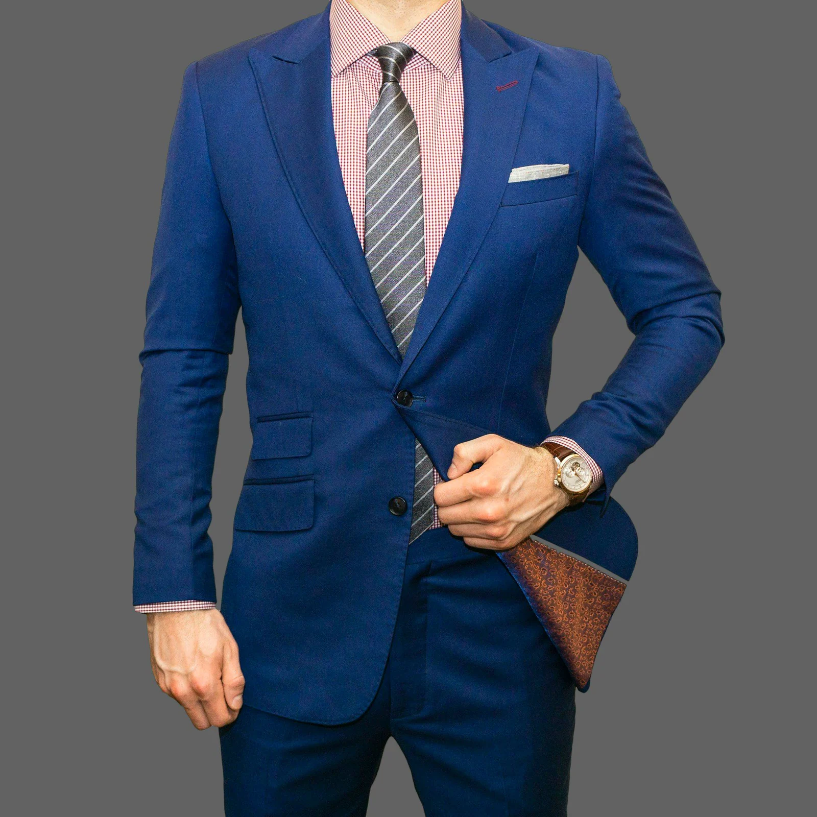 Bright navy business suit with a grey tie and pocket square