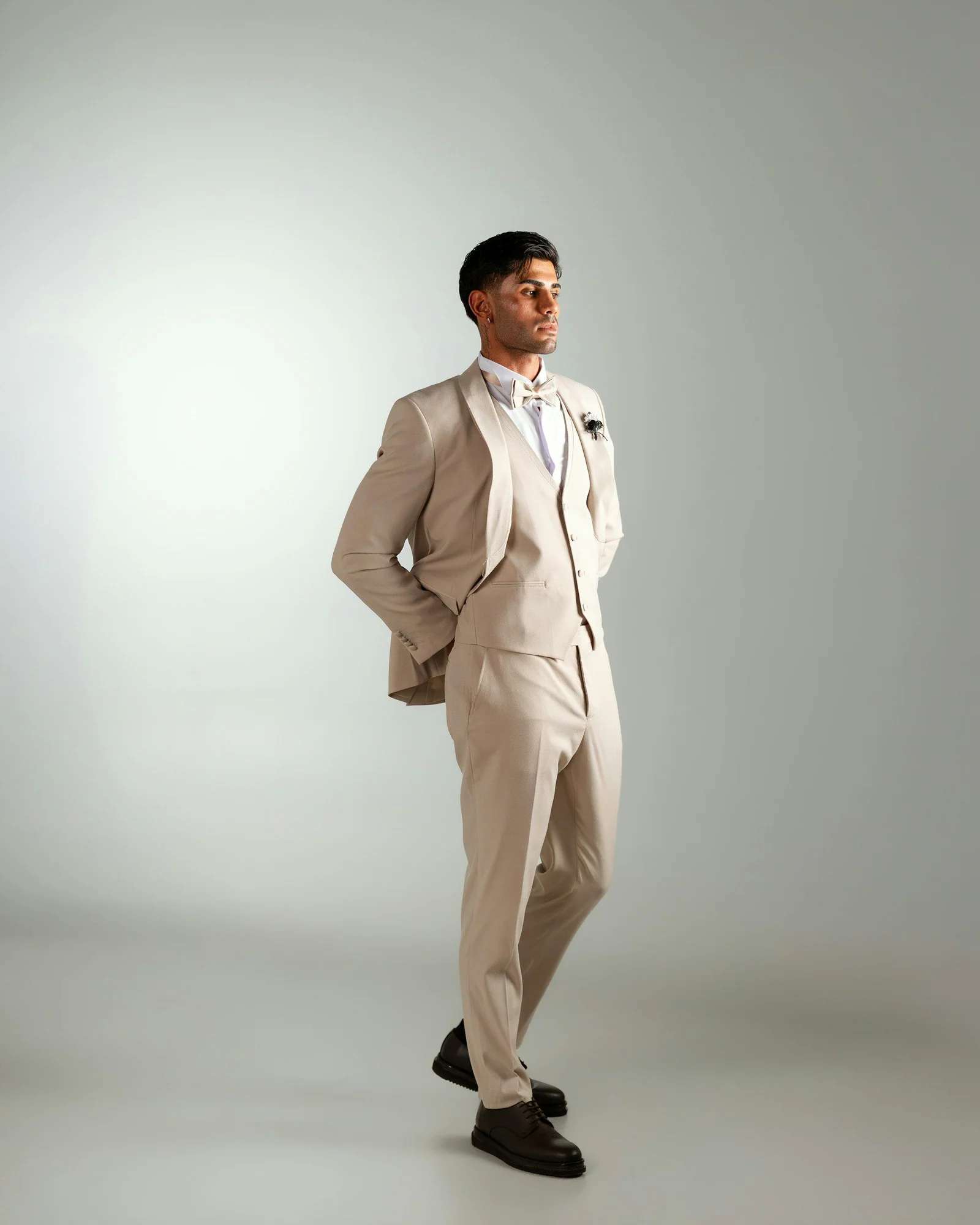 Beige casual suit, full length in the studio