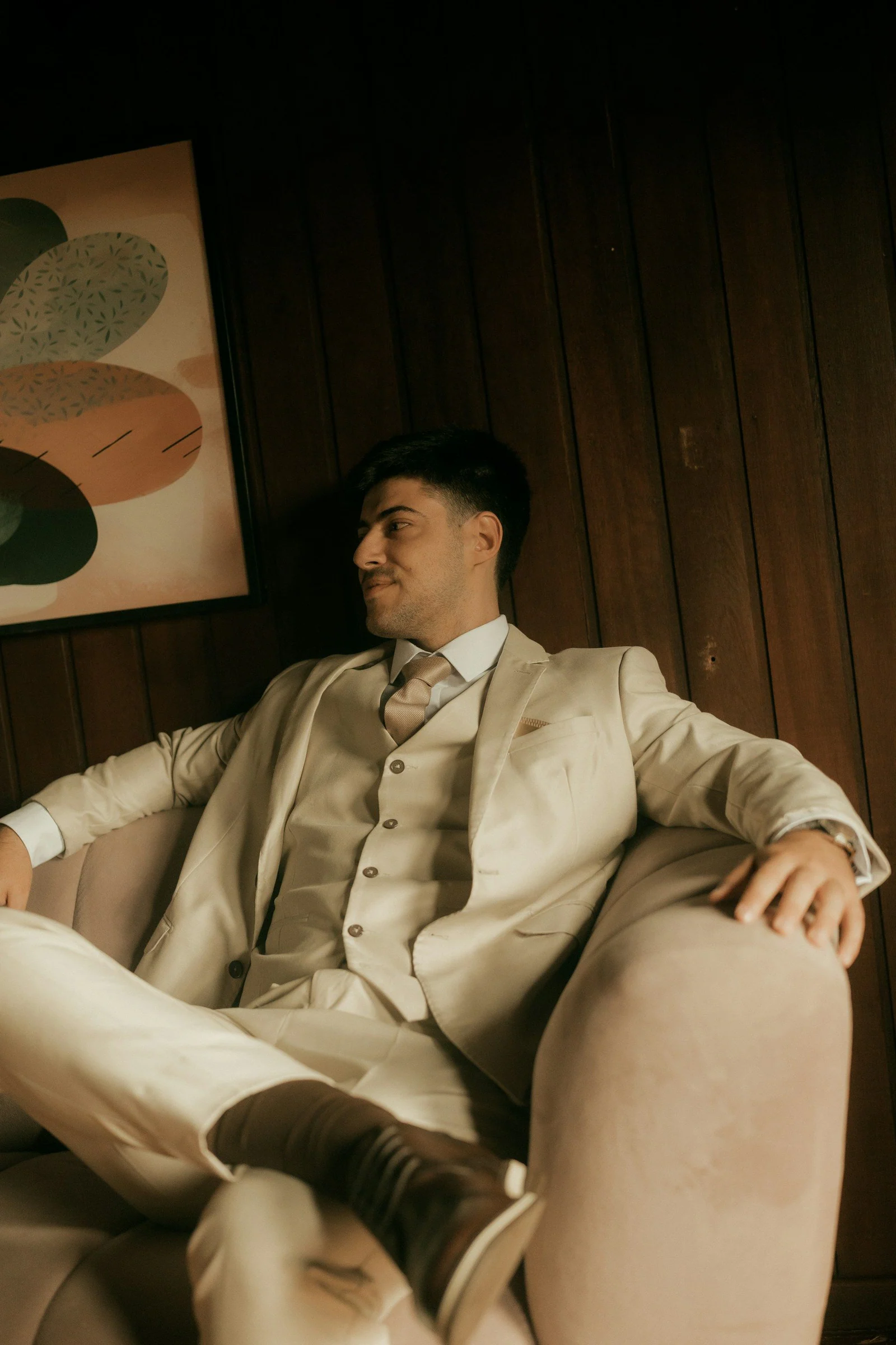 Beige three-piece casual suit, seated