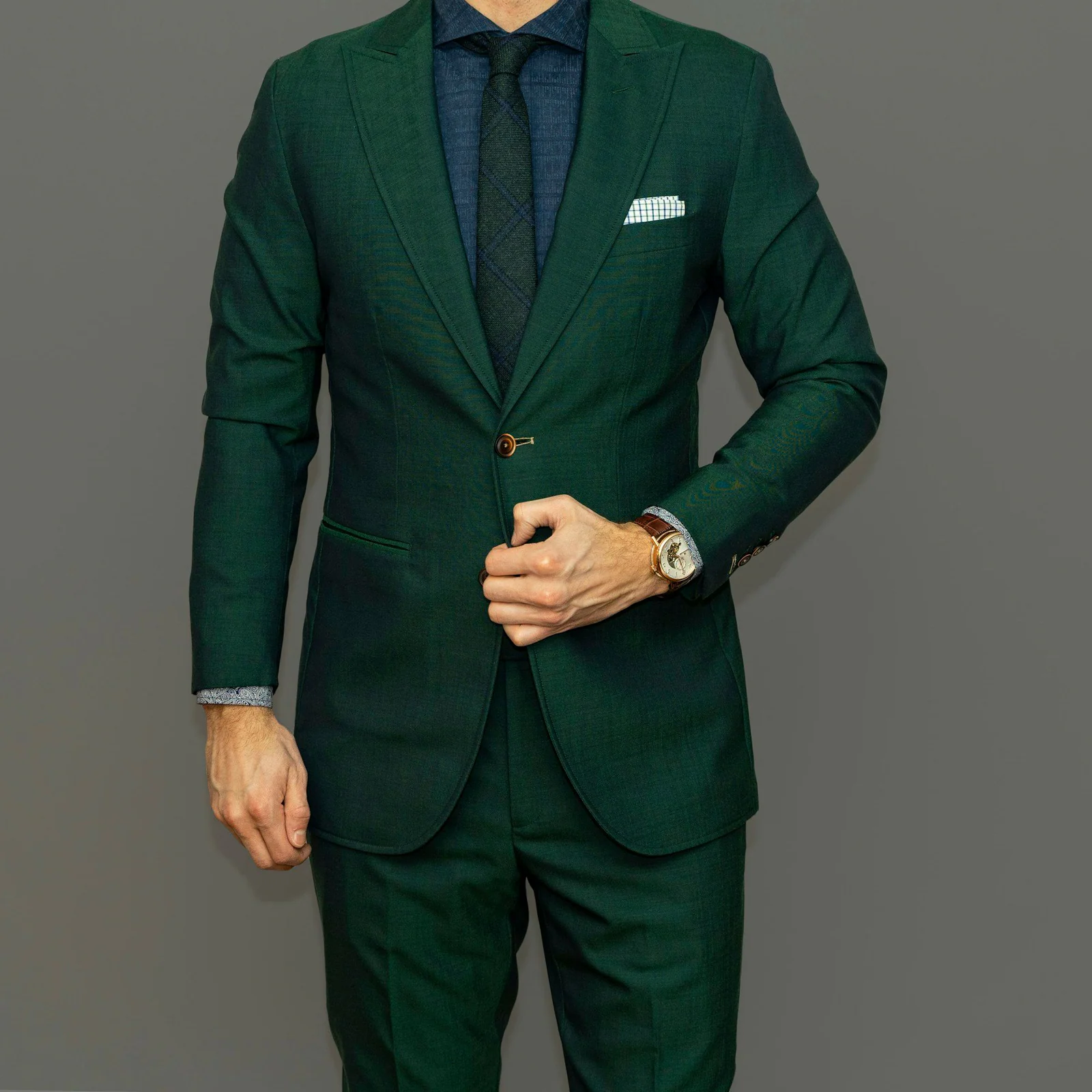 Bespoke bottle-green suit with a pocket square