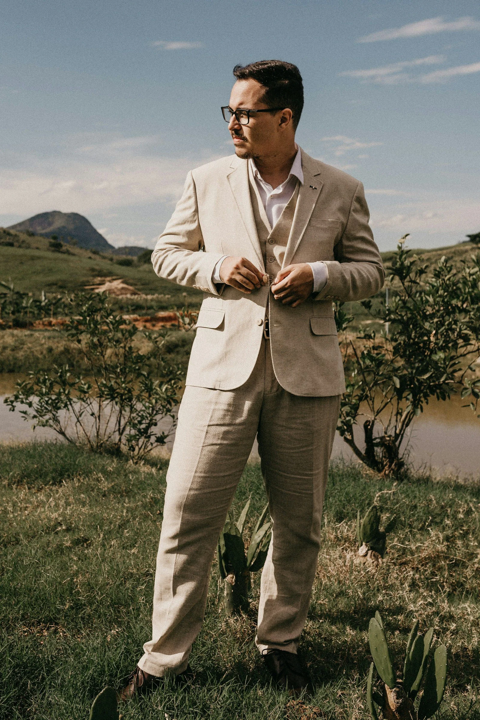 Beige summer suit in an open landscape