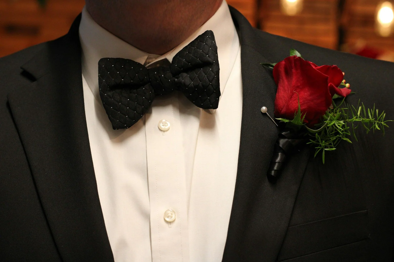 Black silk bow tie, dress shirt studs and buttonhole flower