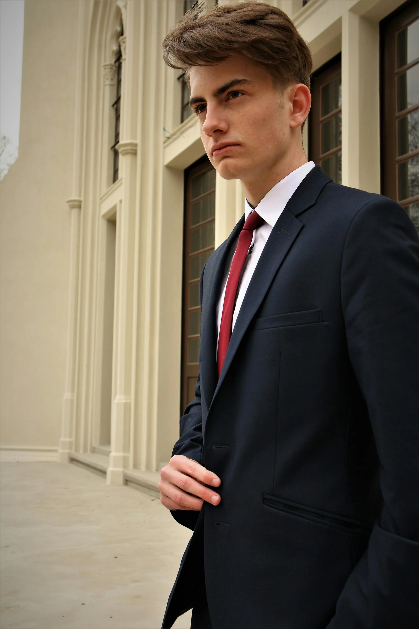 Navy two-piece suit with a red tie